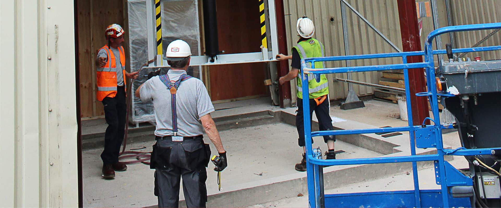workers installing translyft mast lift 